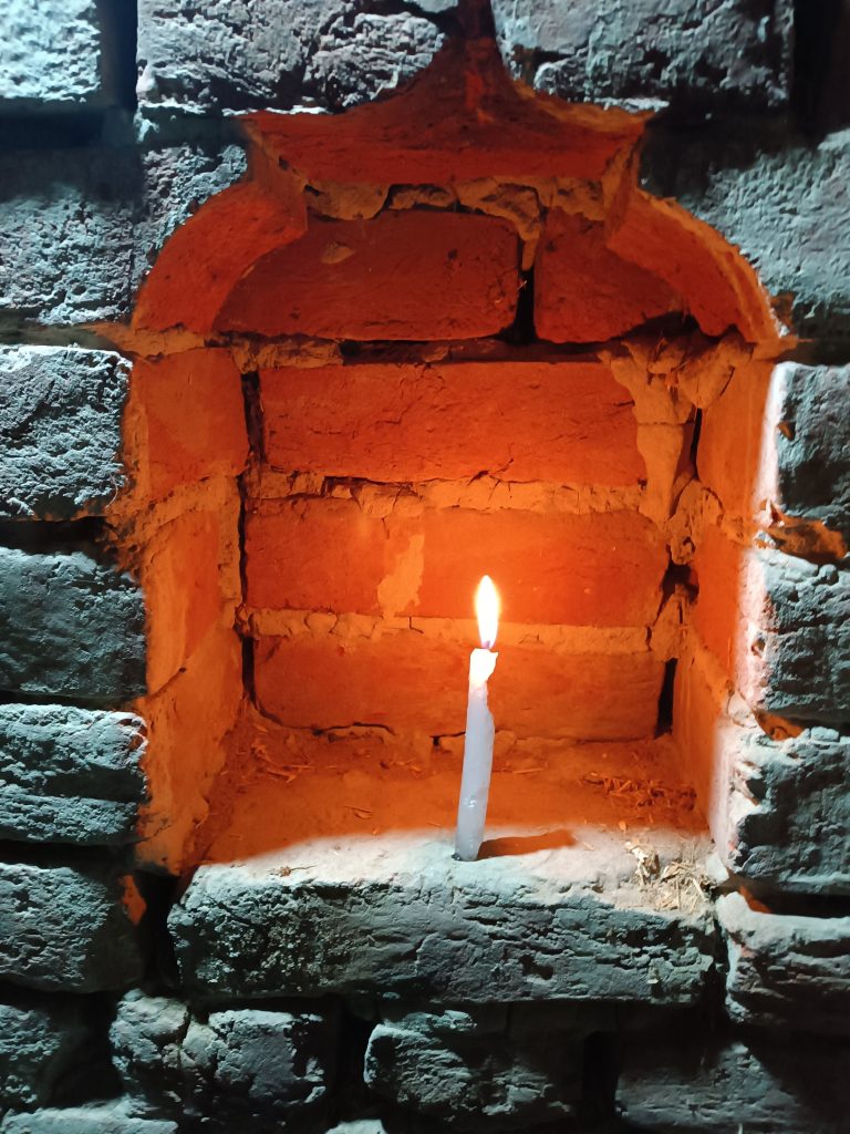 Candle in a fireplace